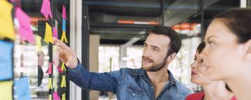 Three Businesspeople Discussing And Planning Concept