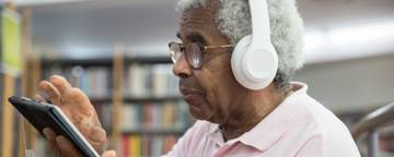 Young Black Man Looking At Laptop
