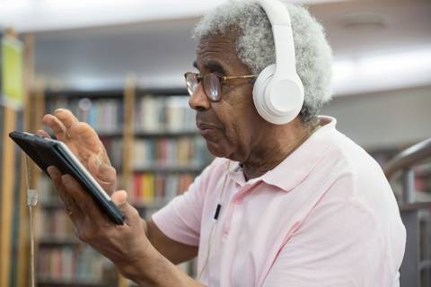 Young Black Man Looking At Laptop